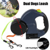 Black dual retractable dog leash with flashlight and two lead clips